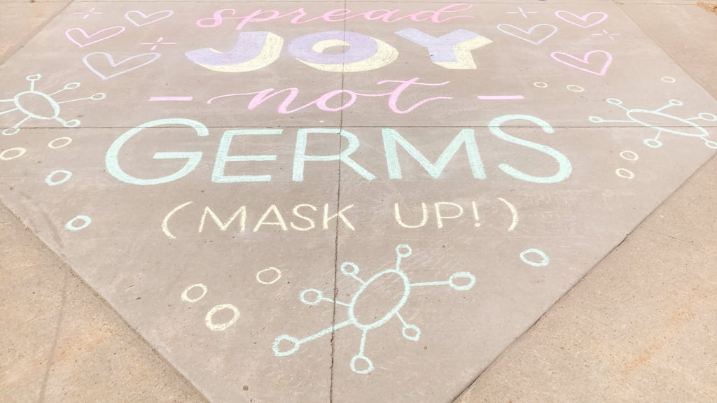 Chalk art reads: Spread joy not germs
