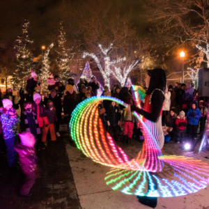 A circus artist spins LED hoops and captivates a crowd